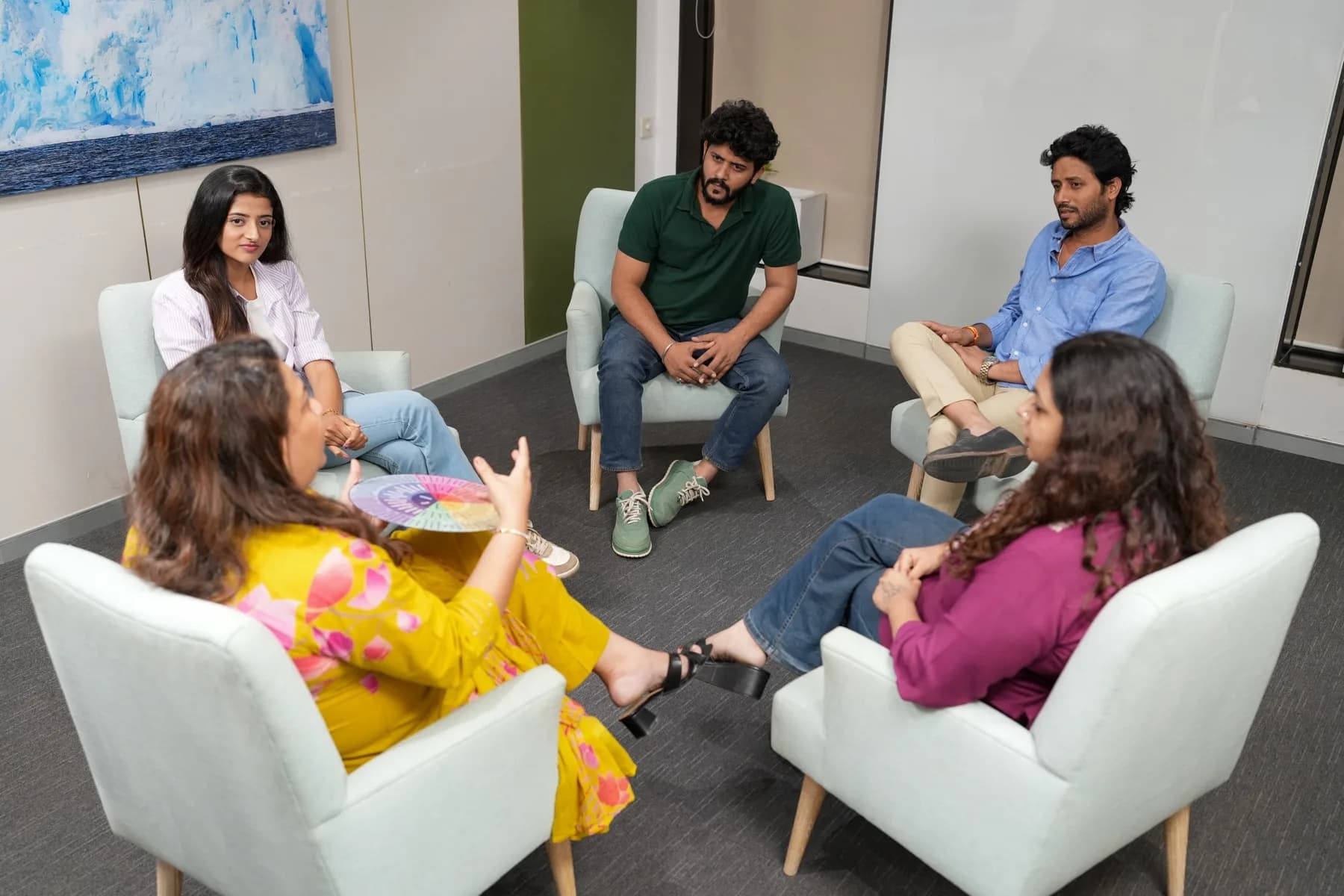 Group members seated in a circle sharing