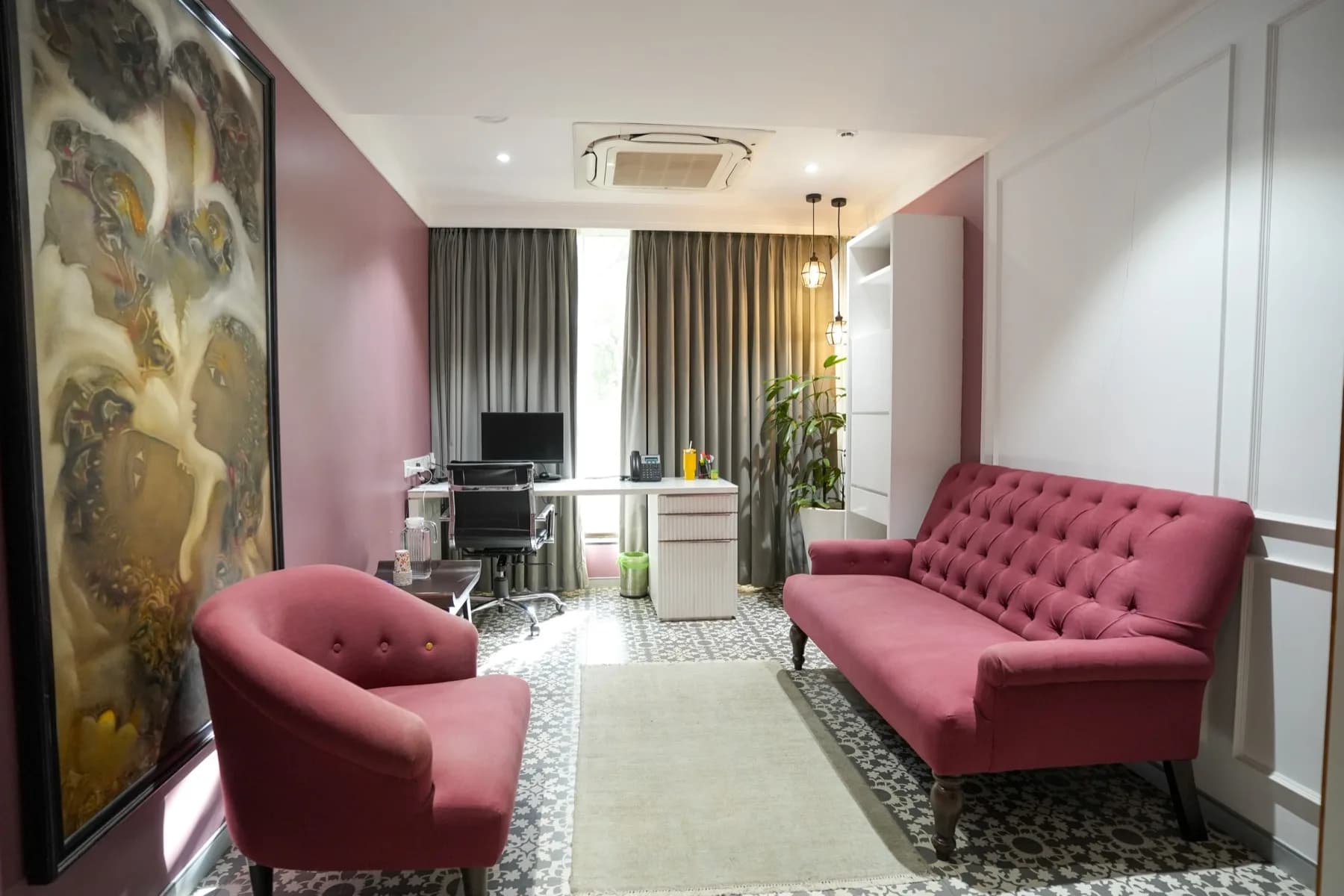 A consulting room in rose with velvet seating