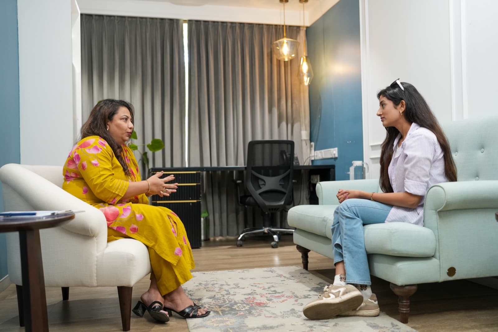 A therapist and client in conversation in a Samarpan consultation room.